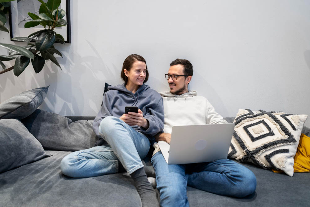 images/couple-working-from-home-together-sofa.jpg